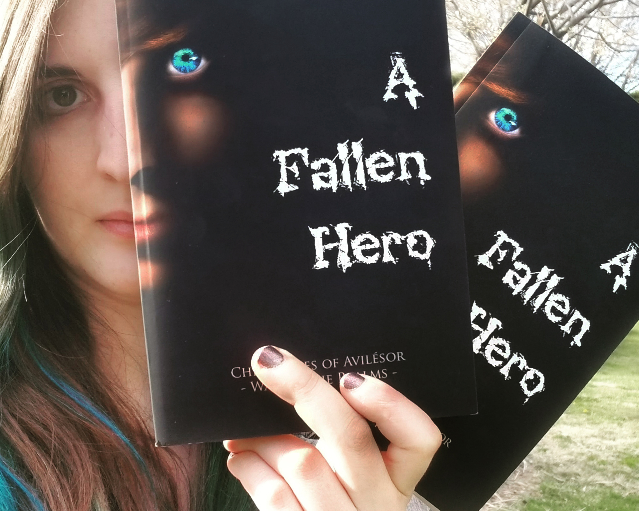 Author Sara A. Noë holding copies of A Fallen Hero published by IngramSpark and Barnes & Noble Press