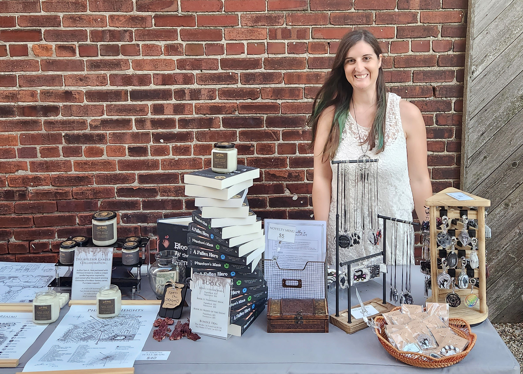 Author and artist Sara A. Noe as a vendor behind her booth