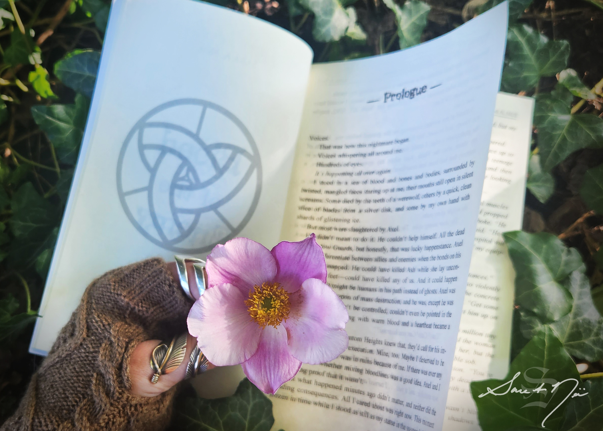 Holding a flower in front of an open book