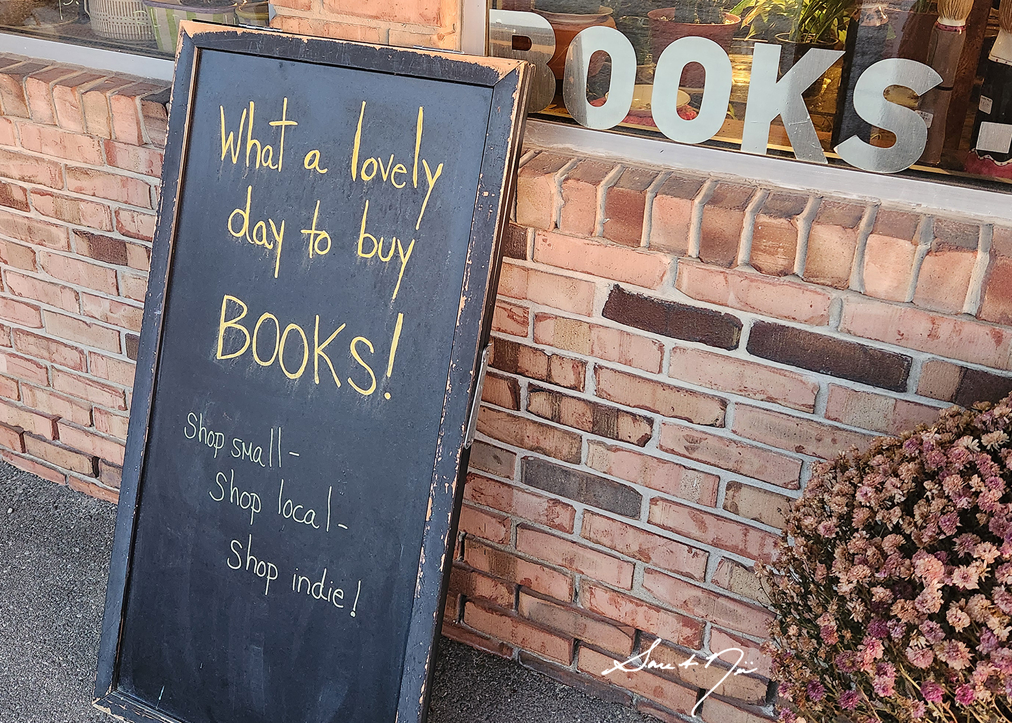 What a lovely day to buy books sign at Flourish Books & Plants